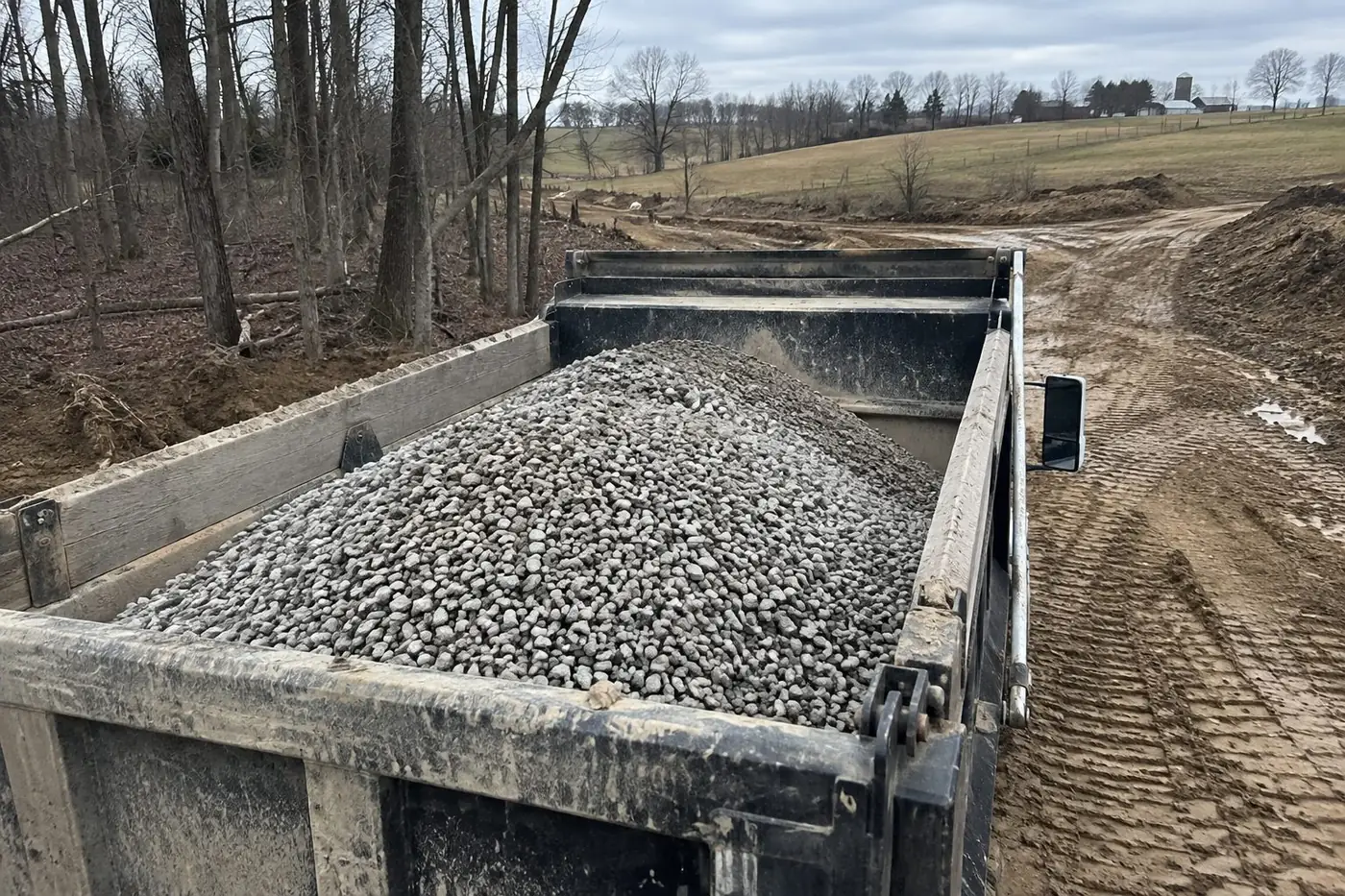 Dump truck loaded with gravel at a rural job site near Dayton, OH