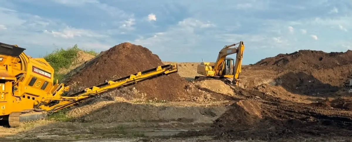 Loader and conveyor working a large topsoil pile near Dayton, OH